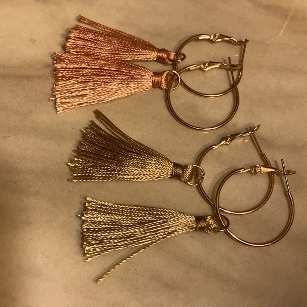 Set of two gold colored hoops with tassels